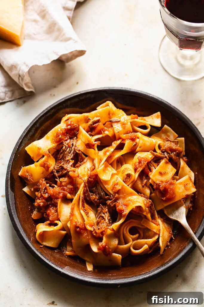 Top down shot of short rib ragu on a plate with a fork