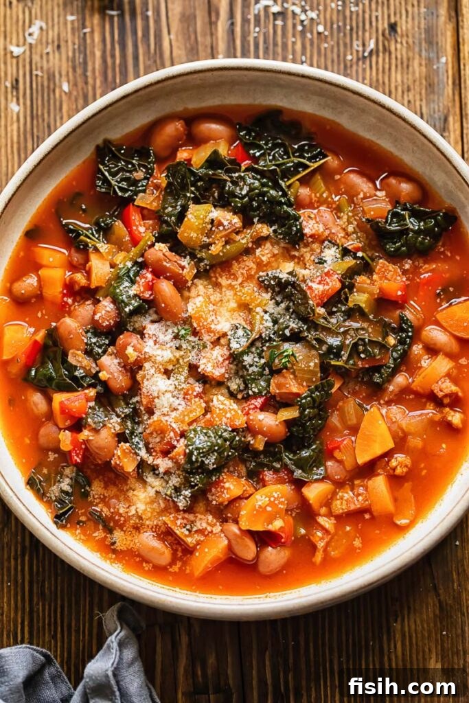 Smoky Chorizo, Bean, and Hearty Vegetable Soup 2 Close up shot of chorizo bean and veg soup in a bowl topped with Parmesan