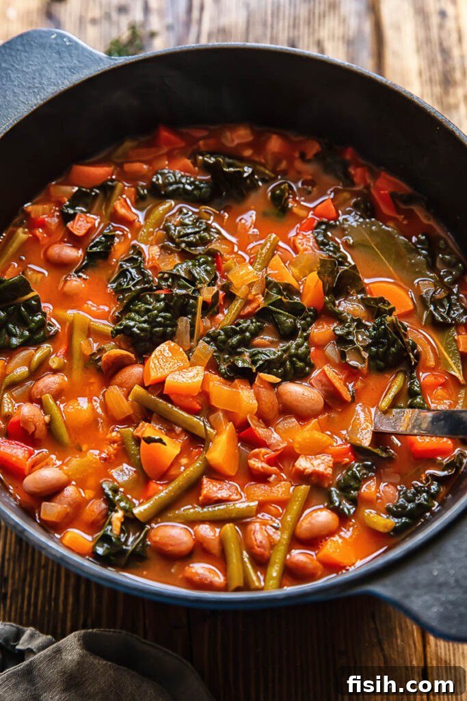 Smoky Chorizo, Bean, and Hearty Vegetable Soup 3 Top down shot of chorizo bean soup in a deep pot with a ladle