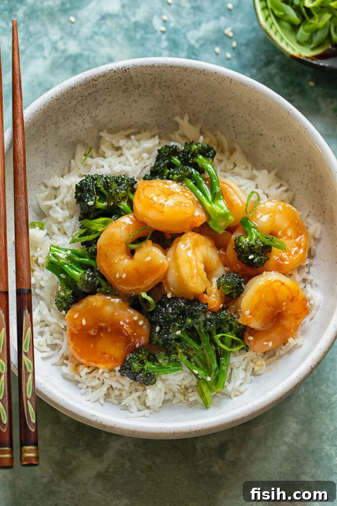 Vibrant Shrimp and Broccoli Stir-Fry 4 Top down shot of shrimp and broccoli stir fry with rice in a bowl with chopsticks