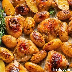 One Pan Honey Mustard Chicken and Potatoes 5 Top down shot of honey mustard chicken thighs in a baking tray with potatoes