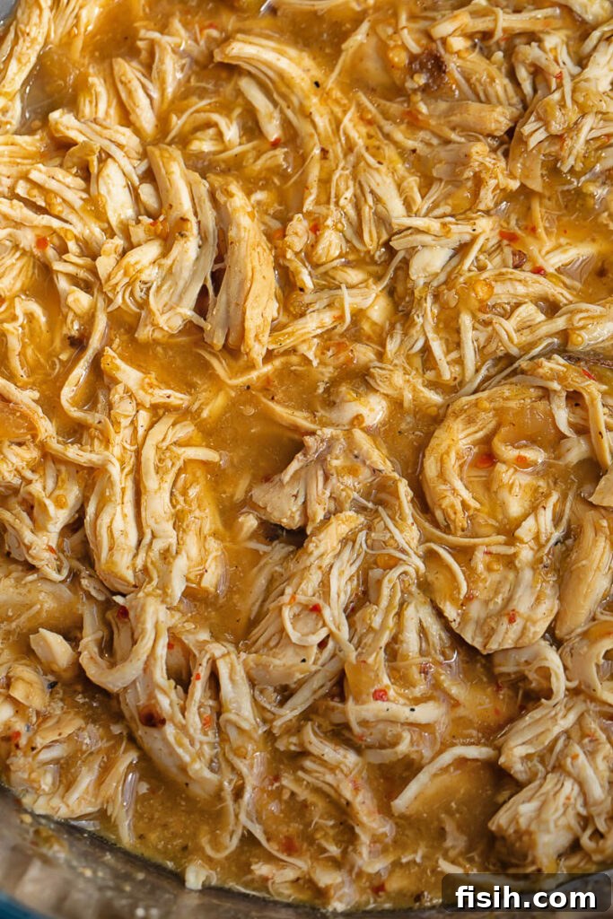 Fiesta Chicken Bowl 3 Close up shot of shredded salsa verde chicken in an instant pot