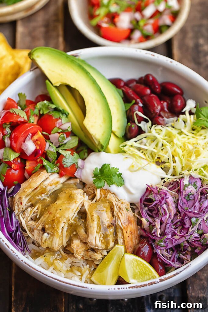 Fiesta Chicken Bowl 4 Close up shot of chicken burrito bowl topped with pico de gallo, slaw and avocado