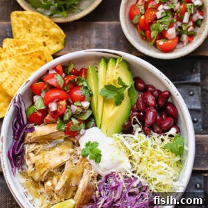 Fiesta Chicken Bowl 6 Top down shot of chicken and rice burrito bowls next to fresh veg and salsa toppings