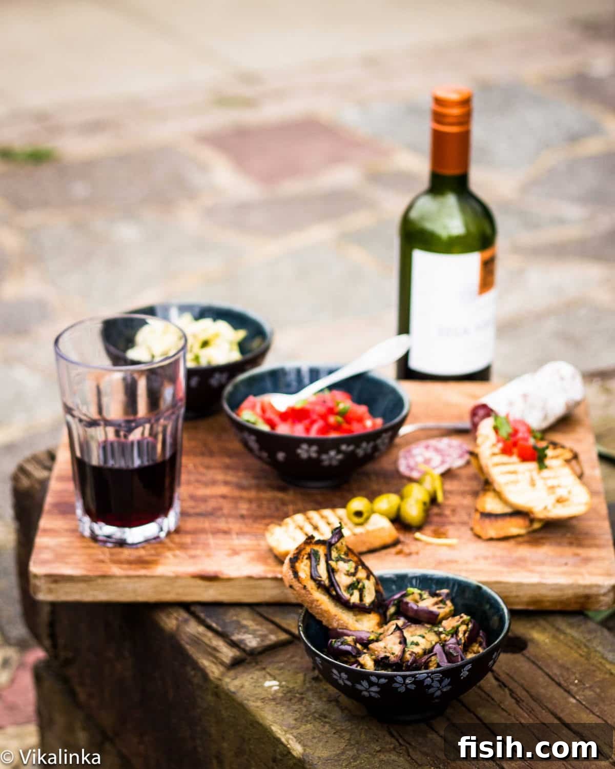 Ultimate Bruschetta Trio 3 An enticing arrangement of Italian Antipasti, showcasing fresh ingredients and gourmet toppings on a wooden board.
