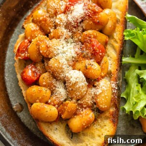 Top down shot of butter beans in tomato sauce on toast