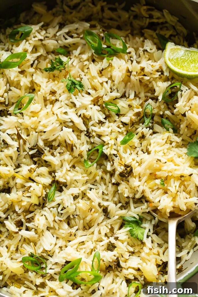 Close up of cilantro lime rice with a serving spoon