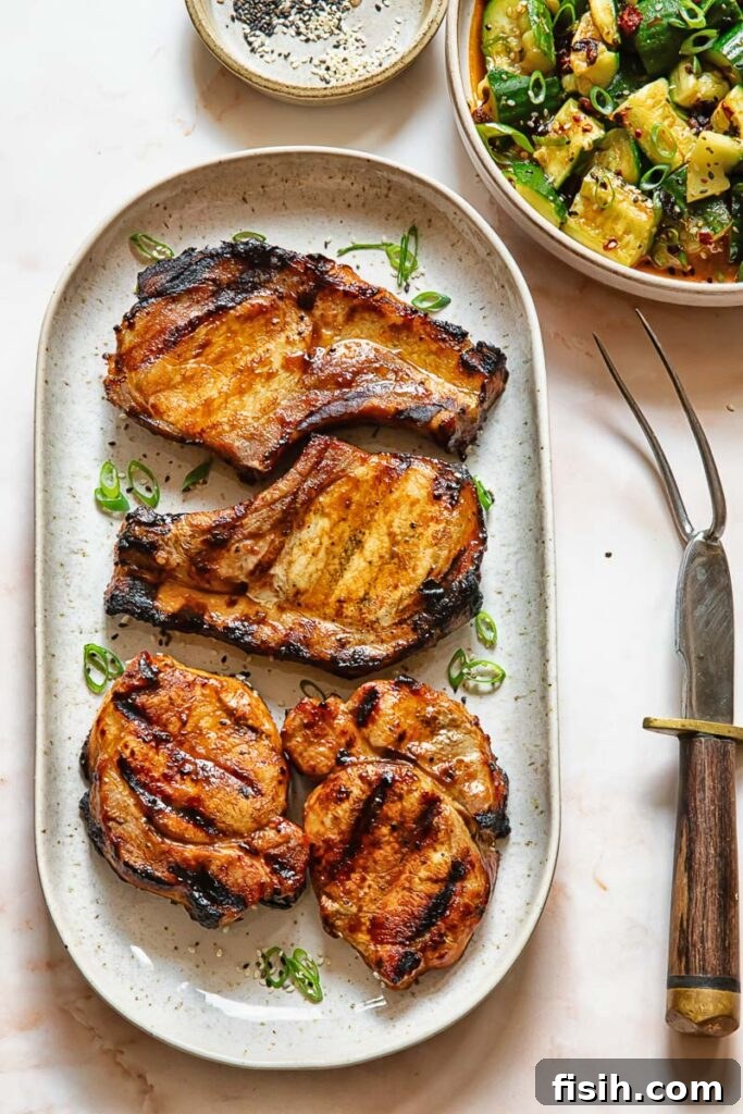 Top down shot of grilled teriyaki pork chops on a serving platter