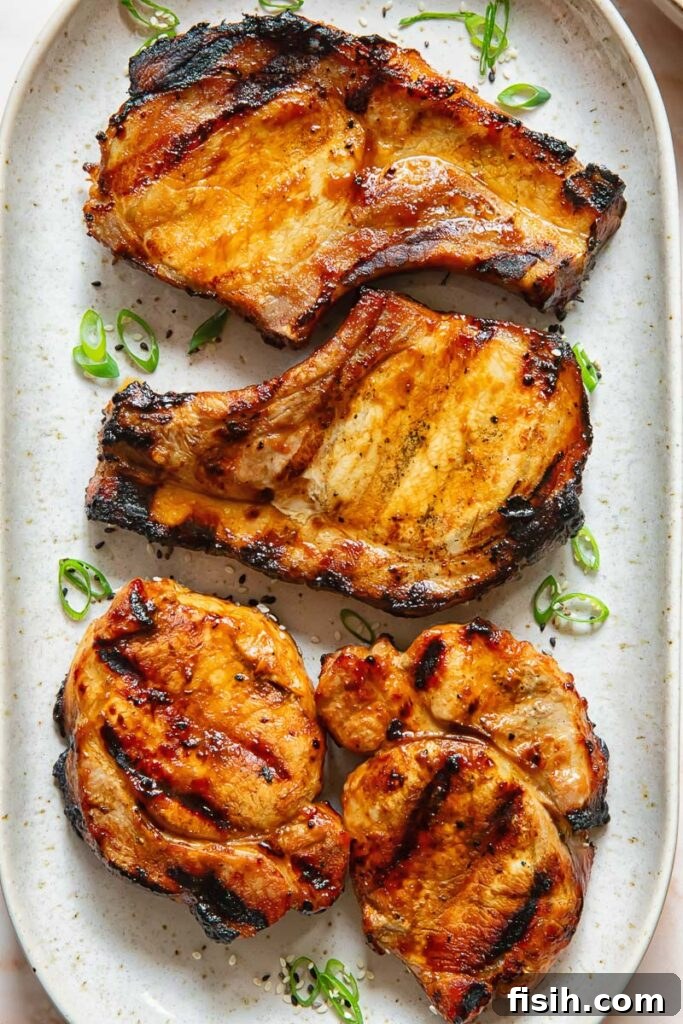 Teriyaki pork chops lined up on a plate