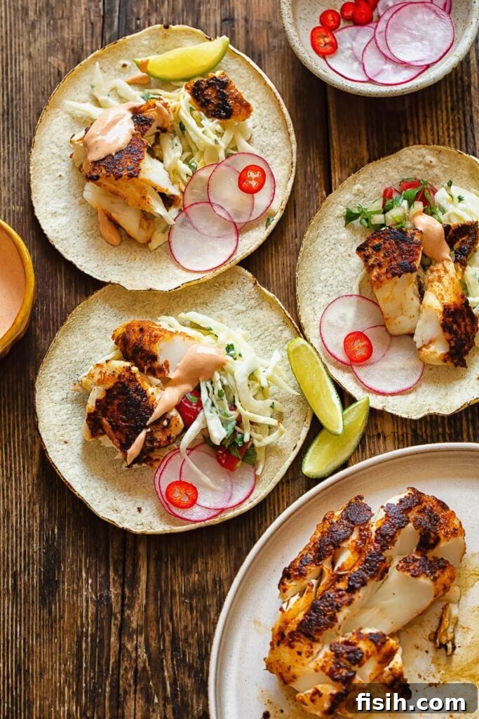 table with several assembled fish tacos