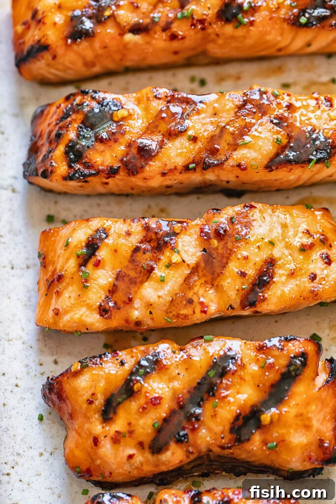 Close up shot of maple glazed salmon fillet slices on a serving board