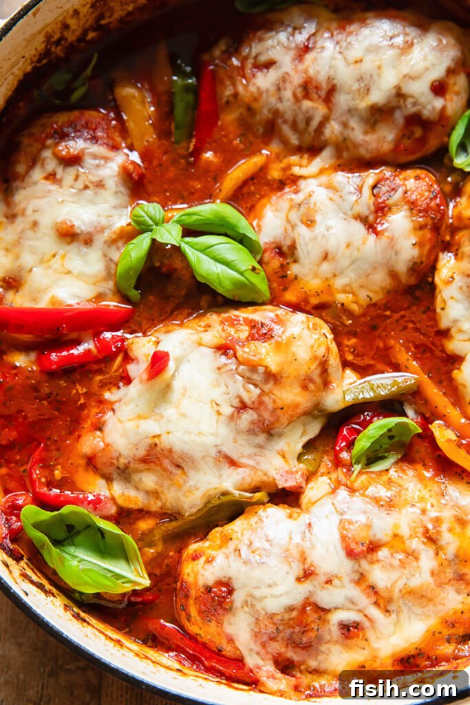 Chicken marinara with bell pepper and basil garnish