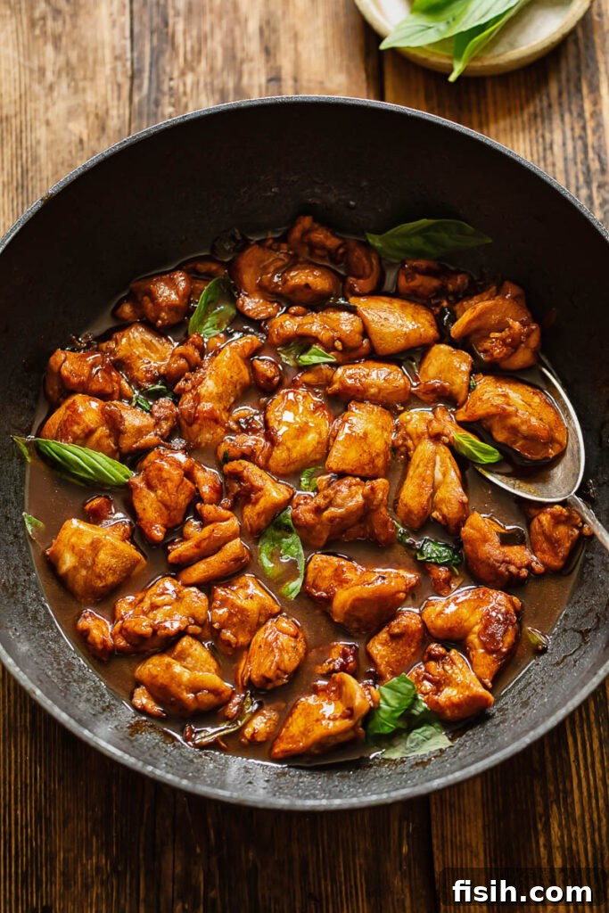 Top down shot of three cup chicken in a pan