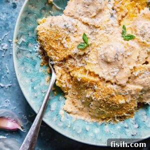 Overhead view of ravioli coated in a rich 5-minute sun-dried tomato cream sauce.