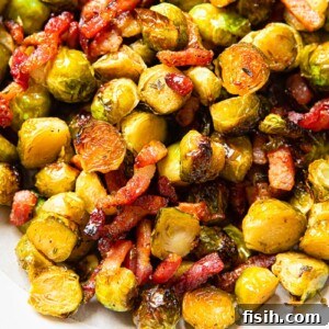 A bowl filled with perfectly roasted Brussels sprouts, adorned with crispy bacon bits and glistening with a sweet honey glaze. A delightful way to enjoy this classic vegetable.