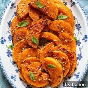 Caramelized Butternut with Fiery Honey 5 Roasted butternut squash slices on a plate with fresh basil garnish