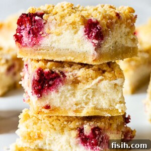 Stacked almond raspberry cheesecake bars with a crumbly topping
