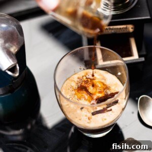 Close up of salted caramel affogato being poured into a clear glass