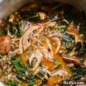 Thai chicken and wild rice soup simmering in a slow cooker, promising deep, rich flavors with minimal effort.