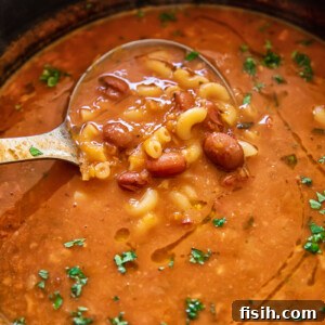 A rustic bowl of Pasta e Fagioli, showcasing the classic Italian combination of small pasta and beans in a rich, comforting broth.