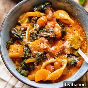 A steaming bowl of Harvest Minestrone Soup with a spoon, filled with colorful vegetables, borlotti beans, and pasta, reflecting autumnal bounty.