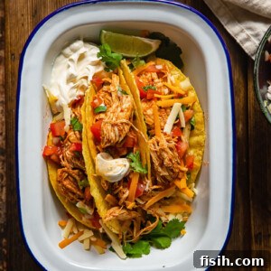 top down view of chicken tacos in a white dish