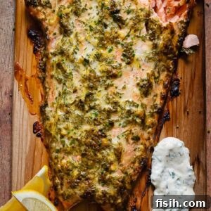 11 Vibrant Salmon Recipes Perfect for Sunny Days 11 A large fillet of cedar plank salmon, cooked on the grill and resting on a wooden cutting board.