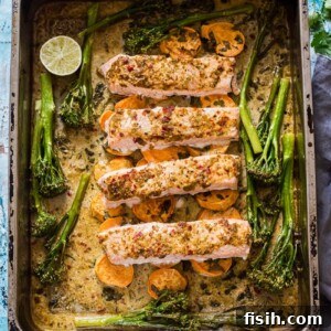 11 Vibrant Salmon Recipes Perfect for Sunny Days 8 A sheet pan with chili garlic salmon fillets, roasted sweet potatoes, and broccoli.