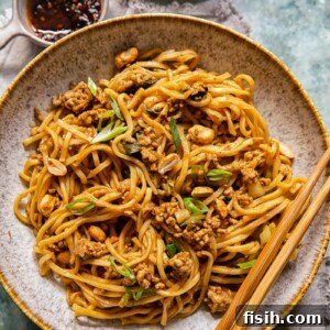 Chinese noodles in a bowl with chopsticks resting on the bowl