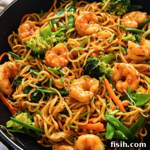 top down view of shrimp with stir fried noodles and vegetables