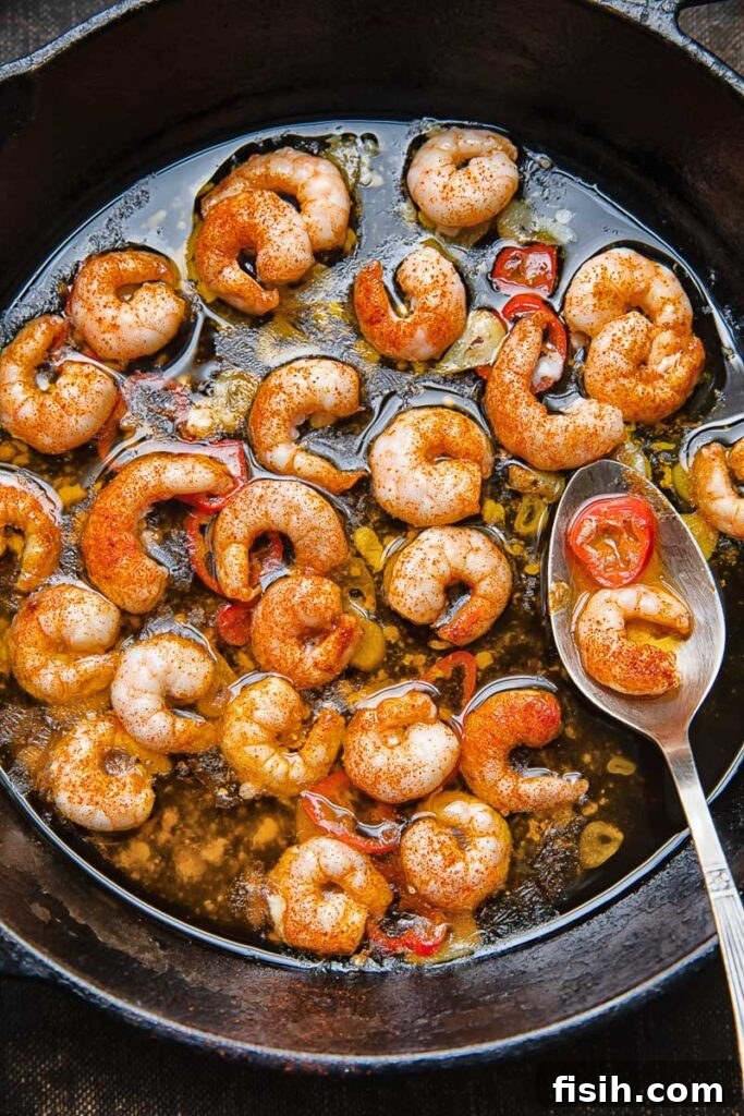 Top down shot of prawns with chilli oil in a pan