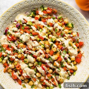 Top down view of Israeli salad with lemon garlic tahini dressing in a bowl