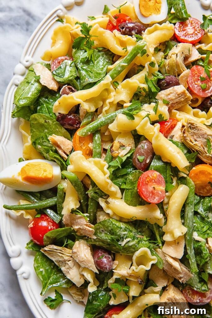 Mediterranean Tuna Nicoise Pasta Salad with Olives 3 Close up of pasta salad with tuna, olives and tomatoes