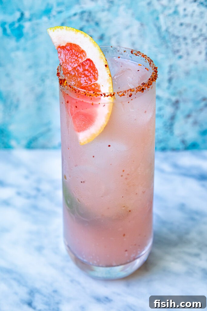 Close up shot of mezcal paloma in a tall glass