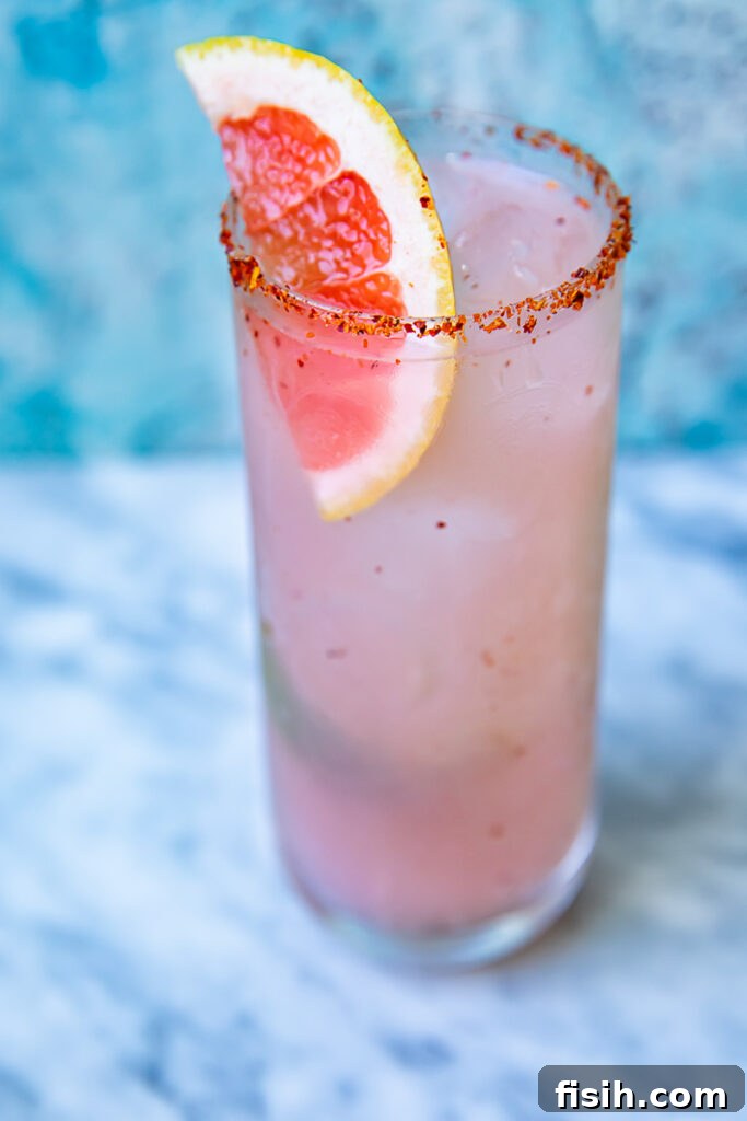 Smoky mezcal paloma with a slice of grapefruit