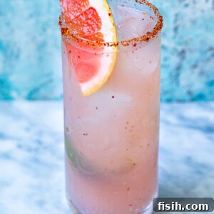 Close up shot of mezcal paloma in a tall glass
