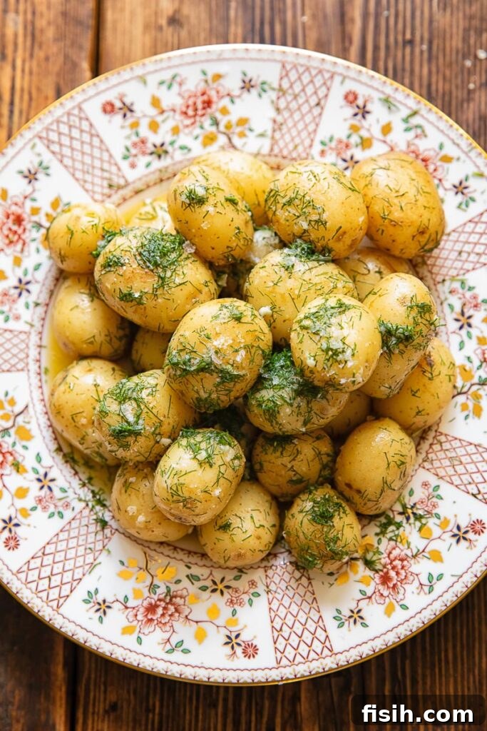 Top down shot of new potatoes with garlic butter on a plate