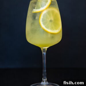 vertical shot of limoncello spritz cocktail against black backdrop