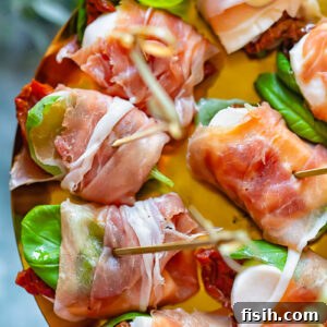 close up of prosciutto caprese bites on a shiny pattern
