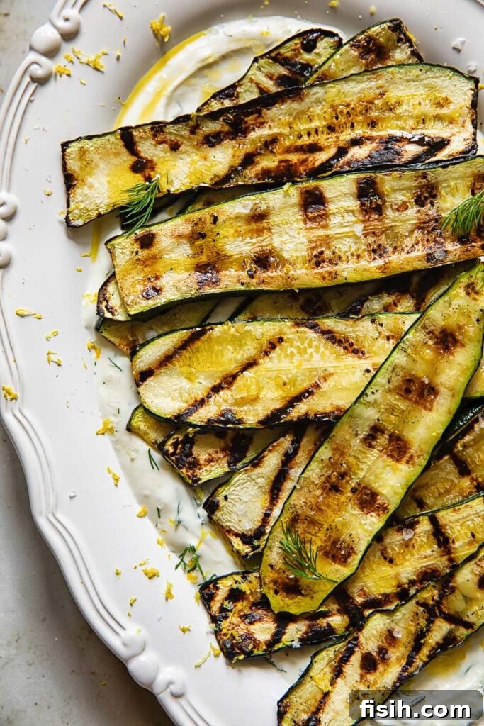 vertical shot of grilled zucchini on a bed of whipped feta