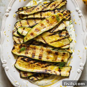 vertical shot of grilled zucchini on a bed of whipped feta