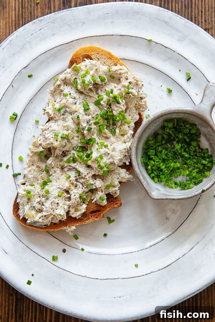 3 Sardine Toast Recipes: Flavorful Ideas for Any Meal 5 Toast on a white plate with a creamy topping plus chopped chives